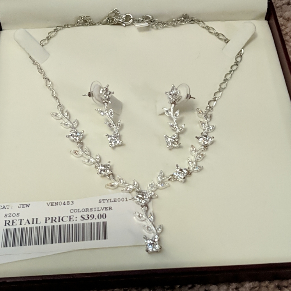 Silver floral necklace with matching earrings.